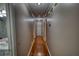 This hallway features beautiful wood floors, neutral walls, and leads to a bathroom at 78 N Pomona Rd, Hampton, GA 30228