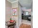 Hallway leading to a living room featuring a fireplace and natural light, creating a welcoming atmosphere at 78 N Pomona Rd, Hampton, GA 30228