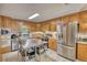 Well-lit kitchen featuring stainless steel appliances, wood cabinets, and a functional island at 78 N Pomona Rd, Hampton, GA 30228