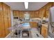 Bright kitchen featuring stainless appliances, wood cabinets, an island, and modern lighting at 78 N Pomona Rd, Hampton, GA 30228