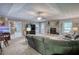Spacious living room featuring a stone fireplace, large television, and open access to the kitchen and dining areas at 78 N Pomona Rd, Hampton, GA 30228