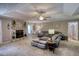 Cozy living room boasting a stone fireplace, plush seating, and a decorative ceiling fan for a comfortable ambiance at 78 N Pomona Rd, Hampton, GA 30228