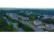 Aerial view of a neighborhood showcasing well-maintained townhomes surrounded by lush greenery and mature trees at 1420 Baygreen Rd, Suwanee, GA 30024