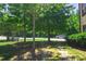 Scenic view of the community park, a bench, and lush green grass under mature trees at 1420 Baygreen Rd, Suwanee, GA 30024