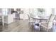 Open kitchen with stainless steel appliances and dining area with seating for six at 1420 Baygreen Rd, Suwanee, GA 30024