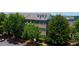 A traditional-style townhome featuring shuttered windows, manicured landscaping, and a private entrance at 1420 Baygreen Rd, Suwanee, GA 30024