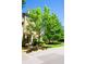 Brick townhouse with covered front door entrance, landscaping, and green trees under a blue sky at 1420 Baygreen Rd, Suwanee, GA 30024