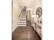 Inviting foyer with hardwood floors, a staircase, and an elegant console table with decorative accents at 1420 Baygreen Rd, Suwanee, GA 30024