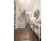 Inviting foyer with hardwood floors, a staircase, and an elegant console table with decorative accents at 1420 Baygreen Rd, Suwanee, GA 30024