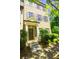 Charming brick townhouse with a covered front door entrance and well-manicured landscaping at 1420 Baygreen Rd, Suwanee, GA 30024