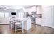 Modern kitchen with island, stainless steel appliances, and seamless flow to living area at 1420 Baygreen Rd, Suwanee, GA 30024