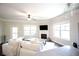 Open-concept living room with fireplace, large windows, and seamless flow to the kitchen, ideal for entertaining at 1420 Baygreen Rd, Suwanee, GA 30024
