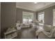 Bright home office with hardwood floors, neutral walls, and natural light from multiple windows at 1420 Baygreen Rd, Suwanee, GA 30024