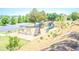 Community playground featuring a swing set, climbing structure, slides, and seating area surrounded by greenery at 1420 Baygreen Rd, Suwanee, GA 30024