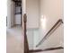 Carpeted staircase with wood handrail leading to an upstairs laundry room, offering practicality and convenience at 1420 Baygreen Rd, Suwanee, GA 30024