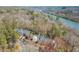 Scenic aerial view of townhomes along the river with mature trees at 220 Riverview Trl, Roswell, GA 30075
