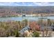 Scenic aerial view of townhomes along the river with mature trees at 220 Riverview Trl, Roswell, GA 30075