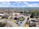 Aerial view of the property with ample parking, outdoor seating, and easy access to surrounding trees at 220 Riverview Trl, Roswell, GA 30075