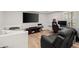 Finished basement with modern entertainment area, plush seating, and a dedicated desk space at 220 Riverview Trl, Roswell, GA 30075