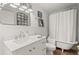 Bright bathroom features a clawfoot tub, marble vanity, and vintage-inspired fixtures at 220 Riverview Trl, Roswell, GA 30075