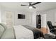 Bright bedroom with hardwood floors, modern ceiling fan, and desk area at 220 Riverview Trl, Roswell, GA 30075