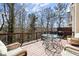 Enjoy wooded views from this spacious deck with comfortable seating, dining, and grilling area at 220 Riverview Trl, Roswell, GA 30075