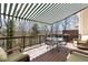 Relax on this beautiful deck, featuring a striped awning, and overlooking a lovely wooded area at 220 Riverview Trl, Roswell, GA 30075