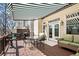 The outdoor deck space includes a striped awning, wrought iron table and comfortable seating at 220 Riverview Trl, Roswell, GA 30075