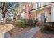 Charming two-story home with brick accents, an American flag, and well-maintained landscaping at 220 Riverview Trl, Roswell, GA 30075