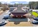 Exterior view of building with Roswell Junction sign, featuring a covered entryway and ample parking at 220 Riverview Trl, Roswell, GA 30075