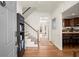 Welcoming foyer with hardwood floors, staircase, and an adjacent kitchen space at 220 Riverview Trl, Roswell, GA 30075