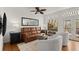 Bright living room with hardwood floors, natural light, and access to the outdoor deck area at 220 Riverview Trl, Roswell, GA 30075