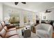 Bright living room featuring a fireplace, hardwood floors, plush seating, and French doors to a balcony at 220 Riverview Trl, Roswell, GA 30075