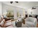 Open-concept living space featuring a fireplace, dining area, and access to a balcony at 220 Riverview Trl, Roswell, GA 30075