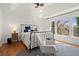 Bright and airy main bedroom with ceiling fan, rocking chair, and scenic backyard views at 220 Riverview Trl, Roswell, GA 30075