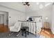 Bright main bedroom features a vaulted ceiling, a ceiling fan, and a rocking chair at 220 Riverview Trl, Roswell, GA 30075