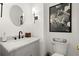 Stylish powder room with marble countertop vanity, modern fixtures, and sophisticated decor at 220 Riverview Trl, Roswell, GA 30075