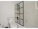 Bright bathroom featuring a tiled shower with a black-framed shower screen at 220 Riverview Trl, Roswell, GA 30075