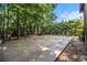This is a view of the backyard with a patio, swing set, and surrounded by shade trees at 2209 Willoby Ct, Morrow, GA 30260
