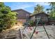 Image shows a backyard with a swing set, a home's brick foundation, and some shade trees at 2209 Willoby Ct, Morrow, GA 30260