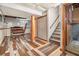 This basement has decorative flooring, stairs to the upper level, and an exposed ceiling at 2209 Willoby Ct, Morrow, GA 30260