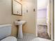 Bathroom with a toilet and pedestal sink and a view into the bedroom at 2209 Willoby Ct, Morrow, GA 30260