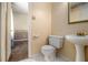 Bathroom with a toilet and pedestal sink and a view into the bedroom at 2209 Willoby Ct, Morrow, GA 30260