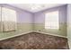 This is an interior view of a bedroom with paneled walls and carpeted flooring at 2209 Willoby Ct, Morrow, GA 30260