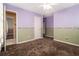 This bedroom features paneled walls, carpeted flooring, and an open doorway at 2209 Willoby Ct, Morrow, GA 30260