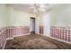 Empty bedroom with ceiling fan, closet and patterned wallpaper at 2209 Willoby Ct, Morrow, GA 30260