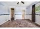 Spacious carpeted bedroom with a ceiling fan, a window with curtains, and two doorways at 2209 Willoby Ct, Morrow, GA 30260
