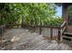 View of a stained wood deck surrounded by shade trees and greenery at 2209 Willoby Ct, Morrow, GA 30260