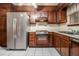 Well-lit kitchen featuring modern refrigerator, dark wood cabinets, and efficient layout at 2209 Willoby Ct, Morrow, GA 30260