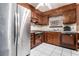 Functional kitchen with stainless steel refrigerator, dark wood cabinets, and tile flooring at 2209 Willoby Ct, Morrow, GA 30260